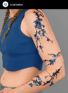 a woman with blue flowers painted on her arms and arm, holding a cell phone