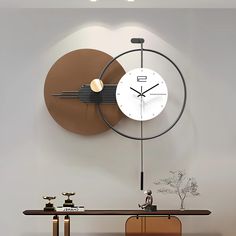 a large clock mounted to the side of a wall next to a wooden table and chair