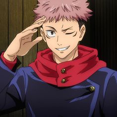 a young man with pink hair and blue eyes is holding his hand to his head