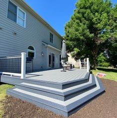 a deck with steps leading up to the house