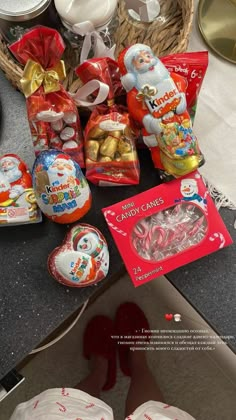 the table is full of candy and candies, including marshmallows in santa claus's hat