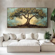 a living room with a couch and large painting on the wall above it that has a tree