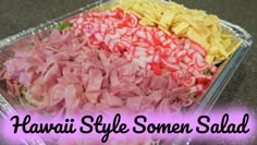 some food is sitting in a tray on the table with words that read hawaiian style somen salad