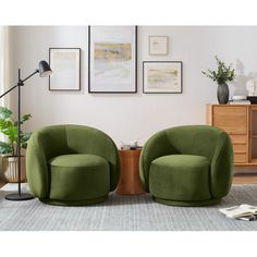 two green chairs sitting next to each other in a living room