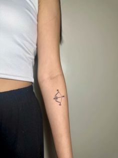 a woman's arm with a tattoo on it and an arrow in the middle