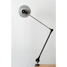 a lamp that is sitting on top of a table next to a wall mounted phone