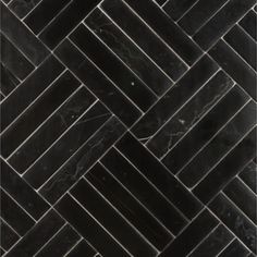 black marble herringbone tile with white veining on the bottom and one diagonal pattern