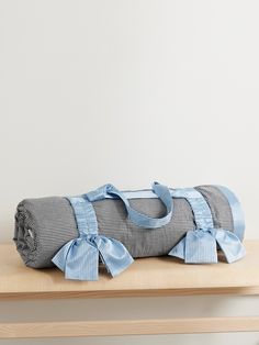 a blue and white blanket sitting on top of a wooden table