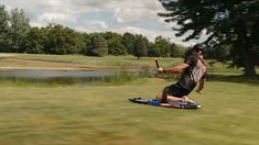 a man riding on top of a wake board