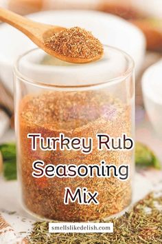 turkey rub seasoning mix in a glass jar with a wooden spoon on the side