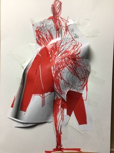 a piece of paper with red and white paint on it that has been torn off