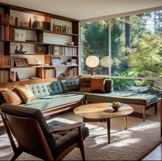 a living room filled with furniture and lots of bookshelves next to a window