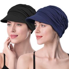 two women in black and blue hats one is wearing a black top the other has a dark blue hat