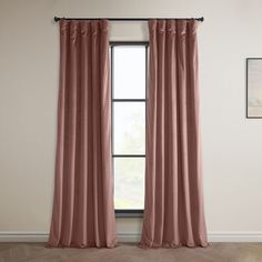 an open window with pink curtains hanging on the wall and wood flooring in front of it