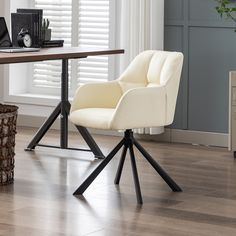 a white chair sitting in front of a wooden table