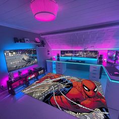 a bed room with a spiderman comforter and two televisions