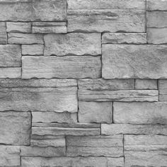 a stone wall that looks like it is made out of grey rocks