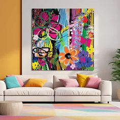 a living room filled with furniture and colorful paintings