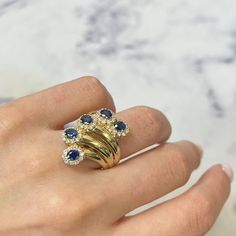 This Stunning Cocktail Ring Comes With A Flashy Statement Look. A Must Have In Your Jewelry Collection. The Ring Is Crafted In 18k Yellow Gold. This Ring Features Oval Cut Blue Sapphires Weighing 1.89cttw Surrounded With Round Brilliant Cut Diamonds Weighing 0.69cttw. Diamond Color G-H And Vs-Si Clarity. Ring Size 6. Weight: 11.9 Grams. Comes With A Presentable Gift Box. Id: 00800 Diamond Cocktail Ring, Blue Sapphire Diamond, Diamond Cocktail Rings, Diamond Color, Sapphire Diamond, Round Brilliant Cut Diamond, Cocktail Ring, Womens Jewelry Rings, Cocktail Rings