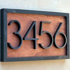 a house number sign mounted to the side of a building