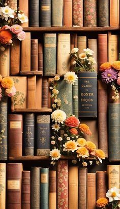 a book shelf filled with lots of books covered in different types of flowers next to each other