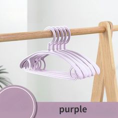 there is a purple hanger on the clothes rack