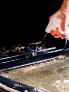 someone is using a spatula to mix ingredients on a baking sheet in the oven