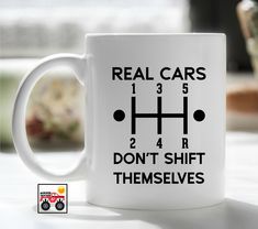 a white coffee mug with the words real cars and don't shift themselves on it