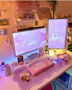 two computer monitors sitting on top of a desk