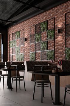 the interior of a restaurant with brick walls and black tables, chairs, and stools