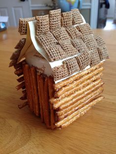 a house made out of crackers sitting on top of a table