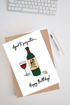 a greeting card with an image of a bottle of wine next to a computer keyboard