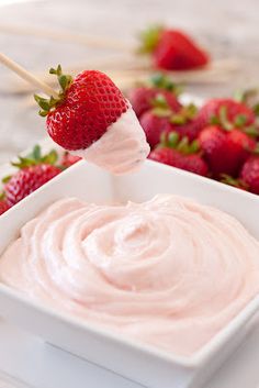 a strawberry dip with strawberries in the background