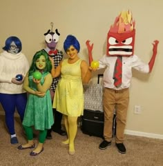 four people in costumes standing next to each other