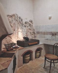 a kitchen with an oven, stove and chair