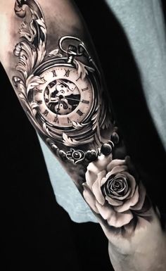 a man's arm with a clock and roses on it