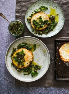 three plates with food on them sitting on a table