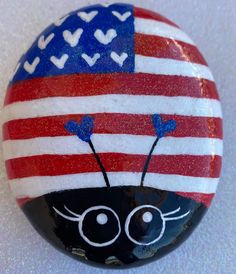 a painted rock with an american flag on it