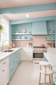 a kitchen with blue and white cabinets, counter tops, and stools in it