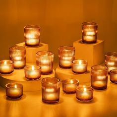 many lit candles sitting on top of each other