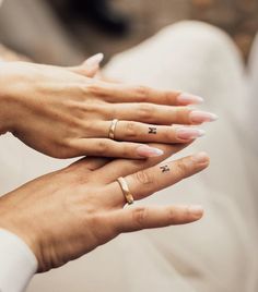 two people with wedding rings on their hands