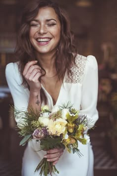 a woman holding a bouquet of flowers in her hands