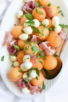 a white plate topped with oranges and other food