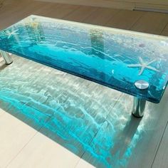 a glass table with starfishs on it in the middle of a flooring area