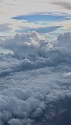 the view from an airplane looking down on some clouds