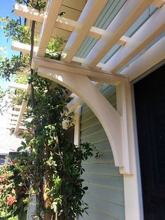 a white trellis on the side of a house