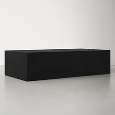 a black rectangular object sitting on top of a white floor