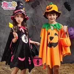 two children in halloween costumes standing next to each other