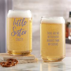 two beer glasses sitting on top of a counter