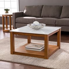 a living room with a couch, coffee table and two end tables on carpeted flooring